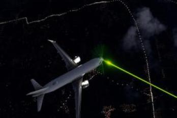 laser and plane in sky
